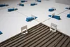 Close-up of white tiles being laid with blue and white leveling clips. Náhľad obrázku produktu