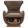 A small dog is resting in the built-in pet bed of a modern armchair. Náhľad obrázku produktu