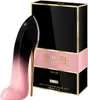 A perfume bottle shaped like a high-heeled shoe next to its packaging. Podgląd zdjęcia produktu