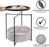 A side view of a round side table with a removable tray on top and a fabric basket underneath. Text overlays describe features. Produktbild-Vorschau