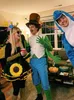 Three people in costumes at a party. Produktbild-Vorschau