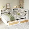 A white multifunctional bed with integrated shelving and storage drawers, set up in a bedroom with a lamp and decorative items. Produktbild-Vorschau