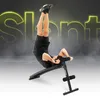 A man is performing an exercise on a slant board, with large neon letters in the background. Anteprima dell’immagine prodotto