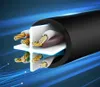 A close-up, cross-section view of a black Ethernet cable, showing its internal wires and structure, against a dynamic blue background with light streaks. Náhled obrázku produktu