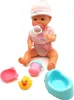 A baby doll with accessories on a white background. Produktbild-Vorschau