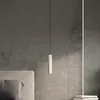 A modern bedroom setting with a pendant light hanging over a bed. Produktbild-Vorschau