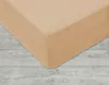 A close-up view of a beige fitted sheet on a wooden floor. Náhled obrázku produktu