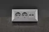 A close-up shot of a white wall socket with two standard European outlets and two USB ports, mounted on a textured gray surface. Anteprima dell’immagine prodotto