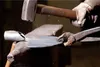 A close-up of a blacksmith working metal on an anvil. Produktbild-Vorschau