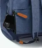 A close-up view of a blue backpack with a phone in a zippered pocket. Voir les images du produit