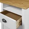 A close-up view of the side of a white desk with an open drawer and a shelf above it. Produktbild-Vorschau