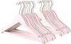 A stack of light pink wooden hangers with silver hooks, neatly arranged. Produktbild-Vorschau