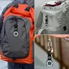 Collage of images showing a carabiner watch attached to backpacks and keys. Produktbild-Vorschau