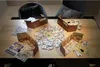 A board game laid out on a wooden table, with chairs in the background. Podgląd zdjęcia produktu