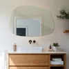 A modern bathroom vanity with a sink, mirror, and wooden cabinetry. Produktbild-Vorschau