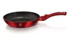 A red frying pan with a black speckled interior and a red handle, shown on a white background. Náhled obrázku produktu