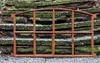 A rusty metal window frame is placed on a stone staircase covered in moss. Produktbild-Vorschau