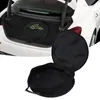 A black carrying bag for EV charging cables is shown in the trunk of a white car, and also separately in the foreground. Podgląd zdjęcia produktu