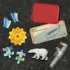 A collection of game pieces and a card are arranged on a dark, textured surface. Podgląd zdjęcia produktu