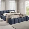 A bedroom with a large upholstered bed. Produktbild-Vorschau