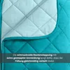 A close-up view of a quilted blanket with diamond stitching, showing two different shades of blue/teal fabric. Produktbild-Vorschau