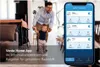 A father and child are in a living room, with a smartphone displaying the Venta Home App in the foreground. Produktbild-Vorschau