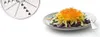 A food processor attachment and a plate of shredded vegetables. Produktbild-Vorschau