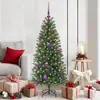 A decorated Christmas tree in a living room setting with gifts and a side table. Produktbild-Vorschau