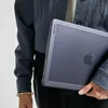 A person holding a laptop in a case. Produktbild-Vorschau