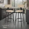 Two bar stools in a modern kitchen setting with a large window in the background. Náhled obrázku produktu