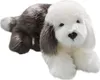 A plush toy dog lying down on a white background. Podgląd zdjęcia produktu