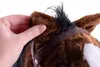 A hand is touching the ear of a plush toy horse. Voir les images du produit