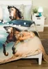 A close-up view of a horse-themed duvet cover and pillow set on a bed. The bedding features a dynamic image of a horse running through dust, with a smaller horse head image on the pillow. Decorative string lights with pastel-colored balls are draped across Produktbild-Vorschau