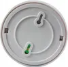 The back of a white smoke detector with mounting holes and a battery compartment. Produktbild-Vorschau