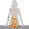 A wooden Christmas pyramid with figures and candle holders, shown next to a silhouette of a person for scale. Produktbild-Vorschau