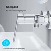 Close-up of a chrome faucet handle and part of a sink, with text overlays. Produktbild-Vorschau