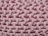 A close-up view of a pink knitted pouf. Náhled obrázku produktu