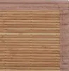 A close-up view of a woven bamboo rug with a fabric border. Produktbild-Vorschau