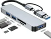 A silver USB hub with multiple ports and card slots, along with various USB drives and memory cards, is displayed against a white background. Produktbild-Vorschau
