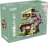 The image shows the packaging for a building block set depicting a Japanese grocery store with a cherry blossom tree. Produktbild-Vorschau