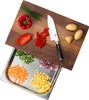 A cutting board with a built-in drawer filled with chopped vegetables. Anteprima dell’immagine prodotto