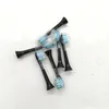 A collection of black toothbrush heads with blue and green bristles, arranged on a white and light gray surface. Produktbild-Vorschau