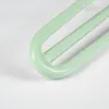 A close-up view of the curved end of three light green hairpin legs, showing their structure and smooth finish. Produktbild-Vorschau