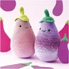 Two crocheted eggplant toys with faces, surrounded by paper cutouts of eggplants. Produktbild-Vorschau