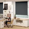 A woman is sitting at a desk in a home office setting, with a large window covered by a roller blind. Voir les images du produit