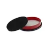 A black foam filter pad is placed next to a red and black container with white filter material inside. Produktbild-Vorschau