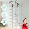 A child giving a thumbs up next to a wall-mounted gym apparatus in a room. Produktbild-Vorschau