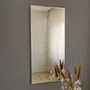A tall, rectangular mirror with a geometric design hangs on a gray wall. Dried floral arrangements are placed in front of the mirror. Náhled obrázku produktu