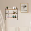 A three-tiered wooden and metal wall shelf is mounted on a light beige wall, displaying various decorative items. Produktbild-Vorschau