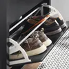 A close-up view of a shoe cabinet with several pairs of shoes stored inside. Náhľad obrázku produktu